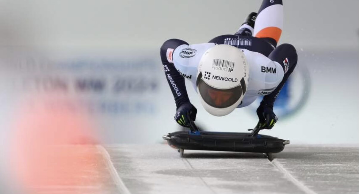 Kimberley Bos racing in skeleton, with the ProductIP logo on her helmet